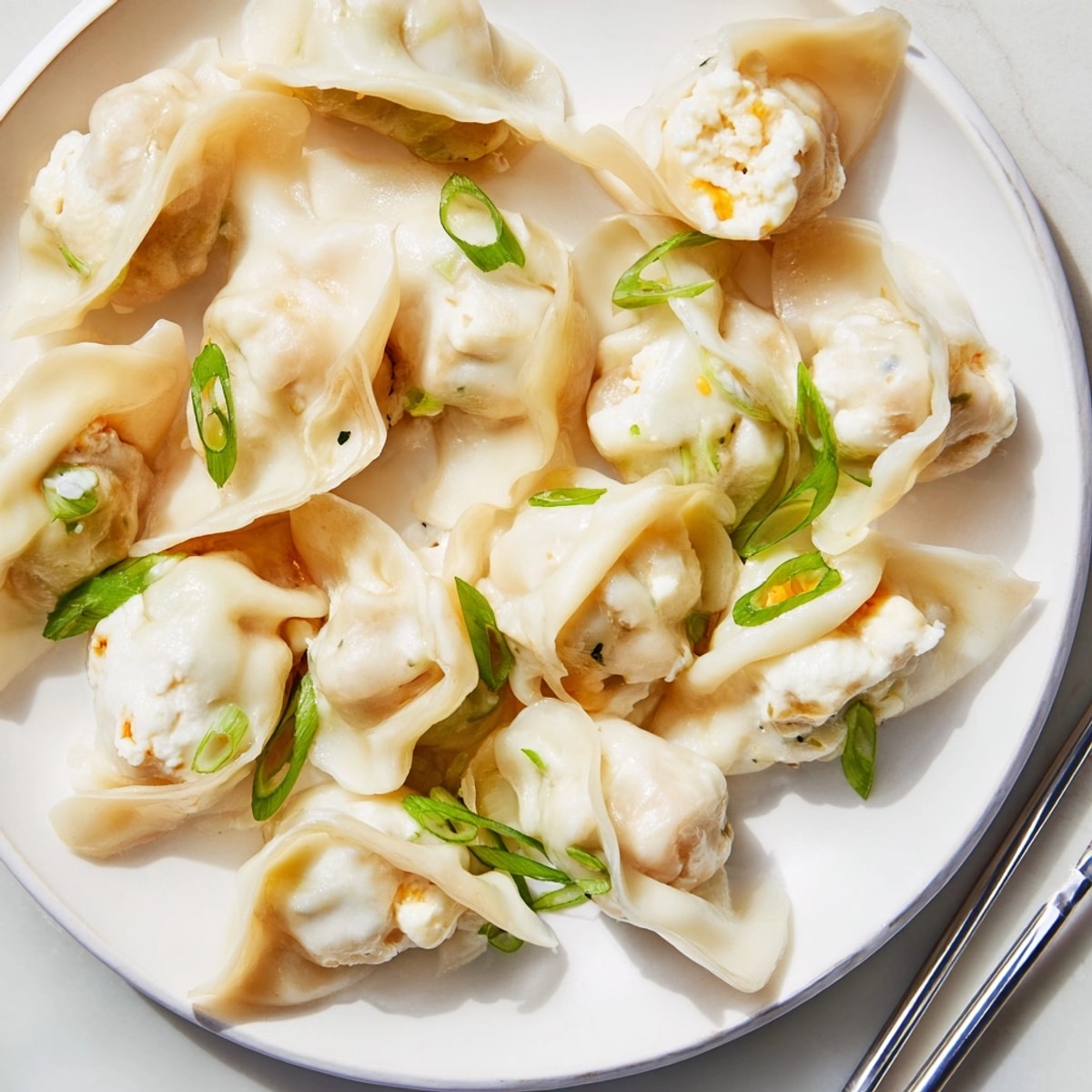 Golden-brown pan-fried Cheesy Shrimp Scallion Dumplings with a satisfying crispy exterior from the skillet.