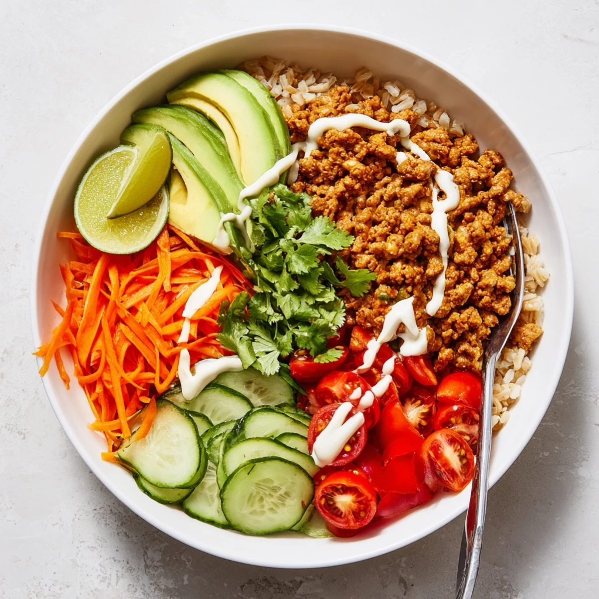 Delicious plant-based meat bowl topped with fresh veggies and spicy mayo sauce.  