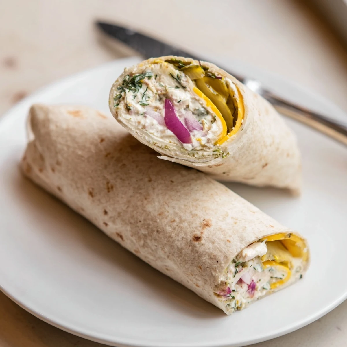 Crisp pickle-in-a-blanket rolls with creamy cheese, a perfect picnic snack.  