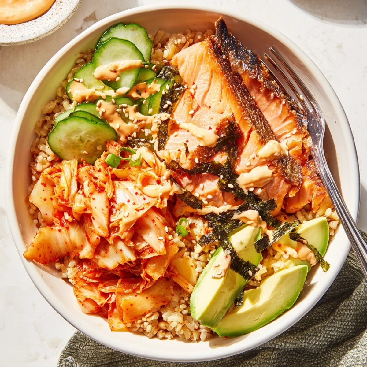 Flavorful Crispy Salmon Rice Bowl garnished with sesame seeds and vibrant vegetables.