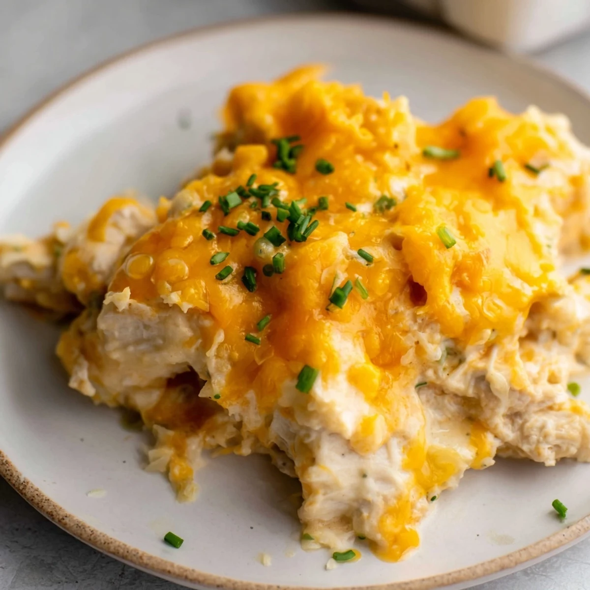 Golden baked Cheddar Ranch Chicken Bake topped with bubbly cheese, ready for serving with sides.