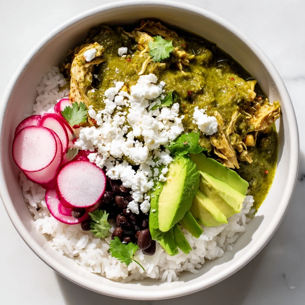A hearty Green Enchiladas Rice Bowl served, showcasing the tender chicken and flavorful green sauce.