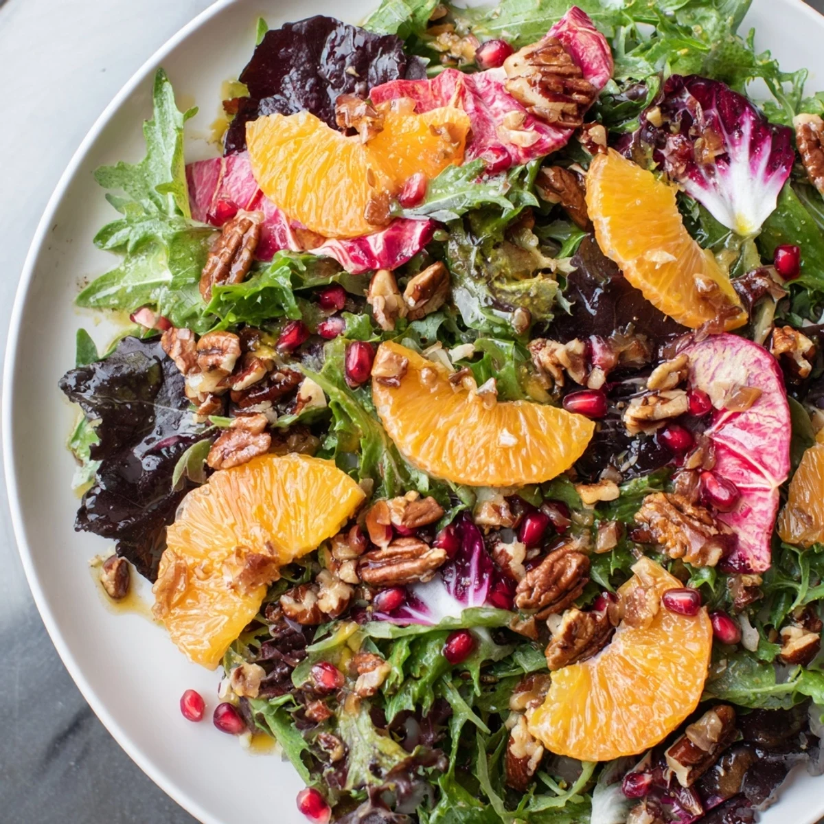 Close-up of a Winter Greens Salad, showcasing bright citrus segments and crunchy toasted nuts.