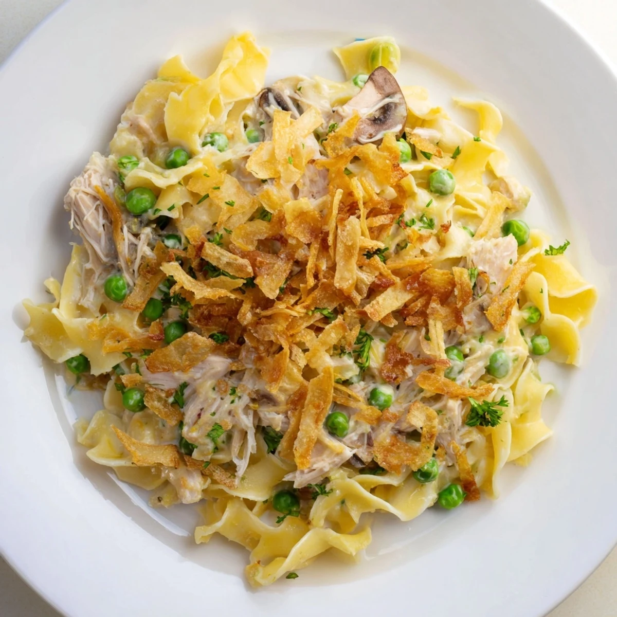 Golden, bubbly tuna noodle casserole with a crispy onion topping, ready to serve and enjoy.