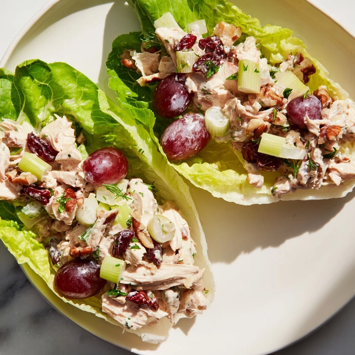 Luscious, creamy festive chicken salad cups bursting with fresh grapes and crunchy pecans, beautifully presented.