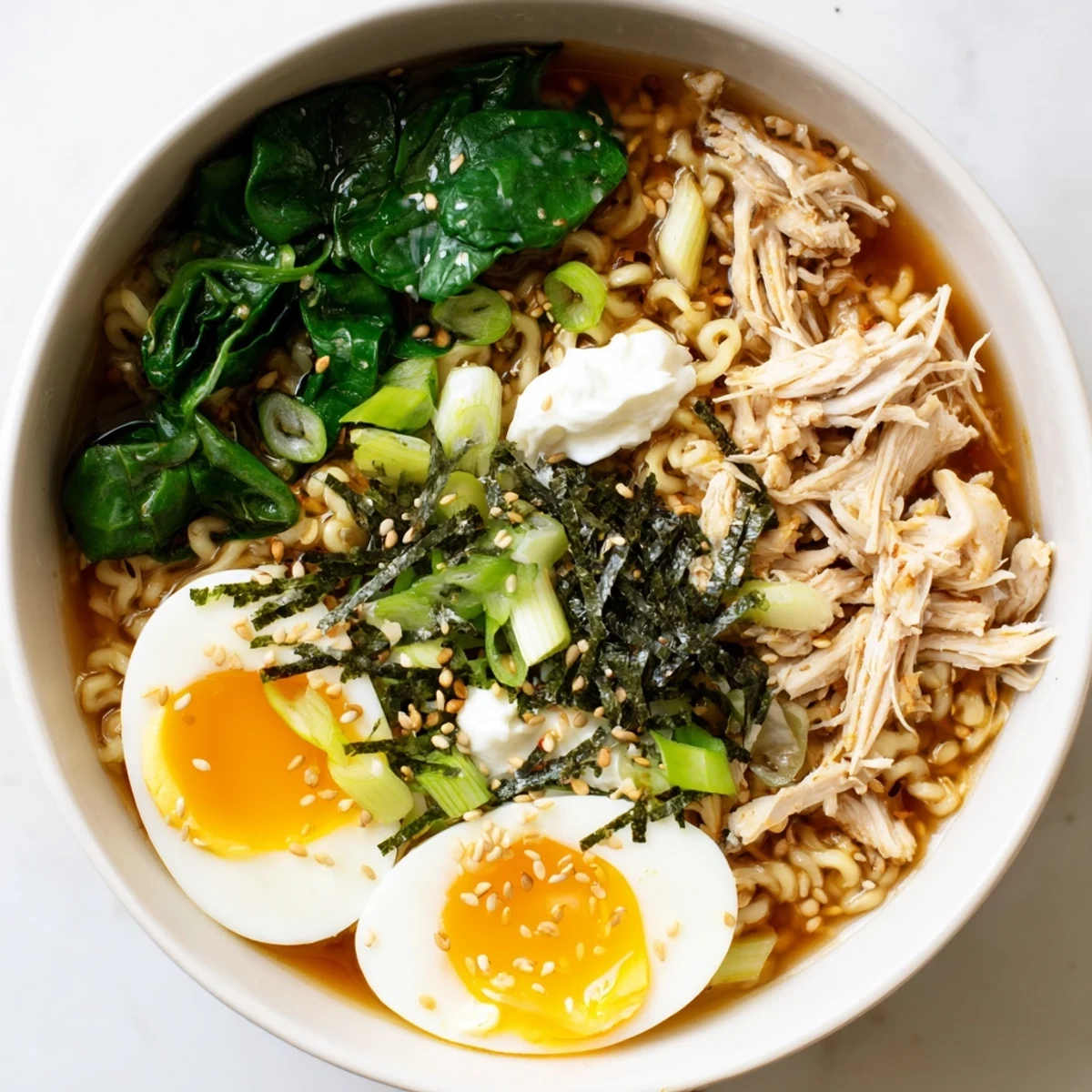 Tender chicken and spinach swimming in flavorful broth: delicious Chicken Ramen with Kewpie Mayo.