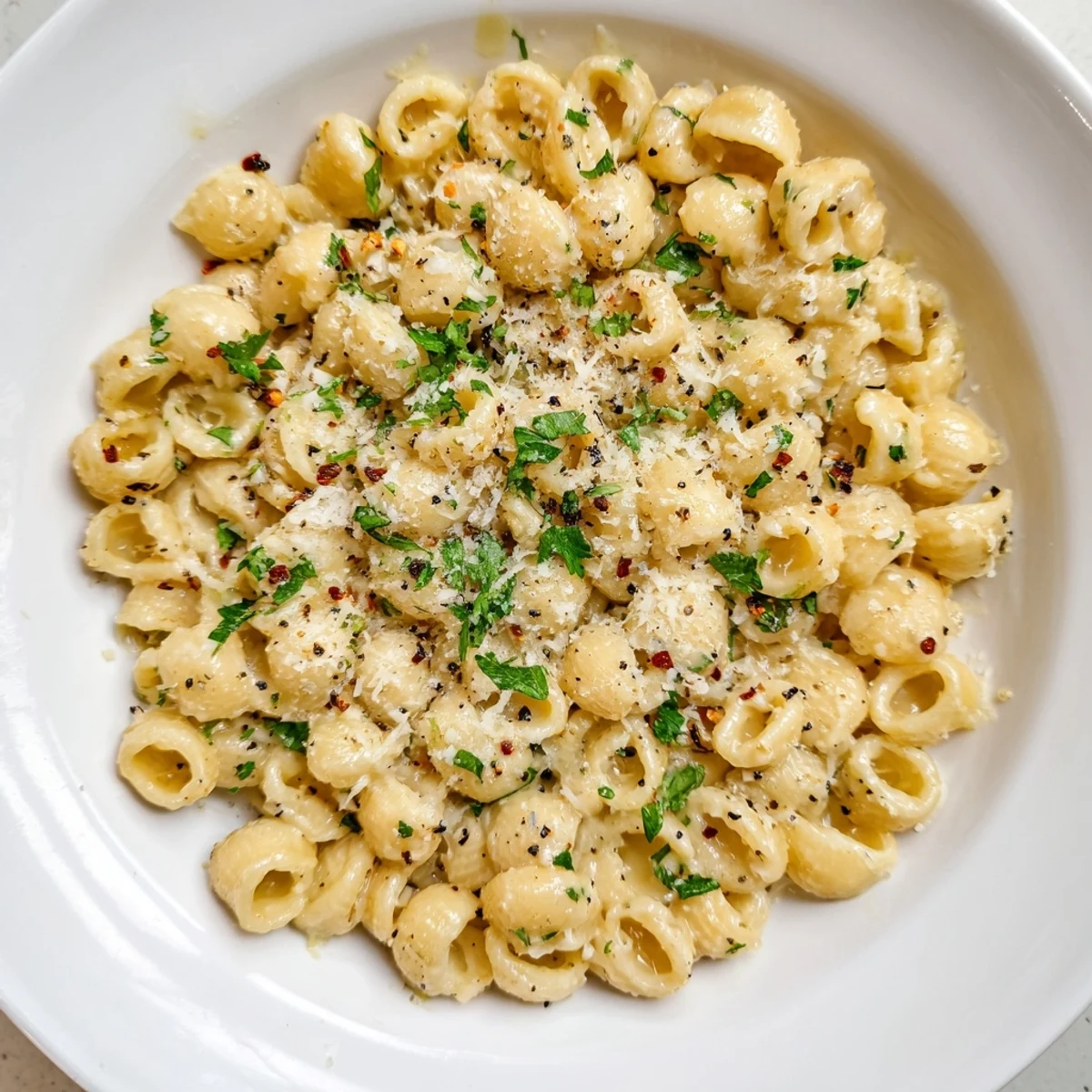 Tender ditalini pasta coated in a rich, creamy garlic sauce, perfect for a cozy, vegetarian dinner.