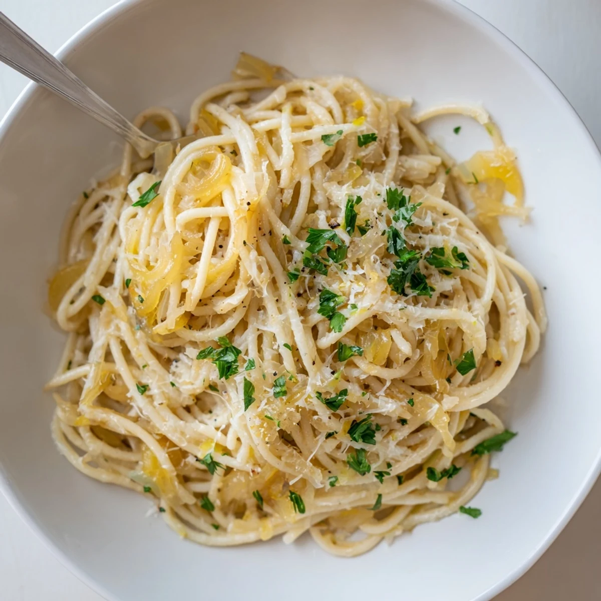 Golden, caramelized onions topping a bowl of One-Pot French Onion Pasta, ready for a warm meal.