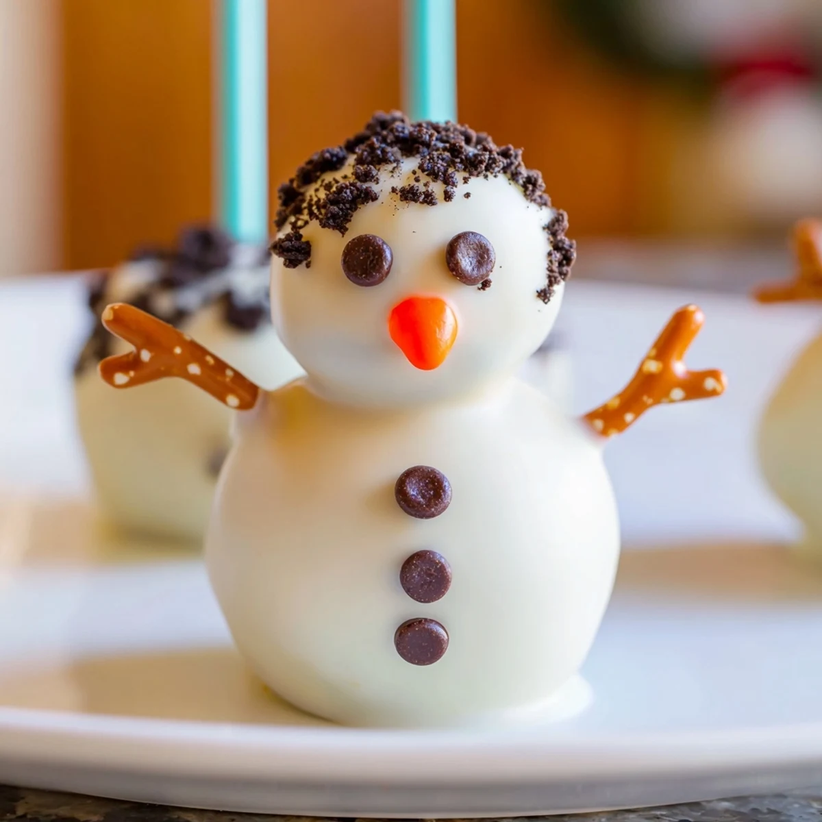 Oreo Snowman Cake Pops, coated in white chocolate, ready for a winter holiday treat.