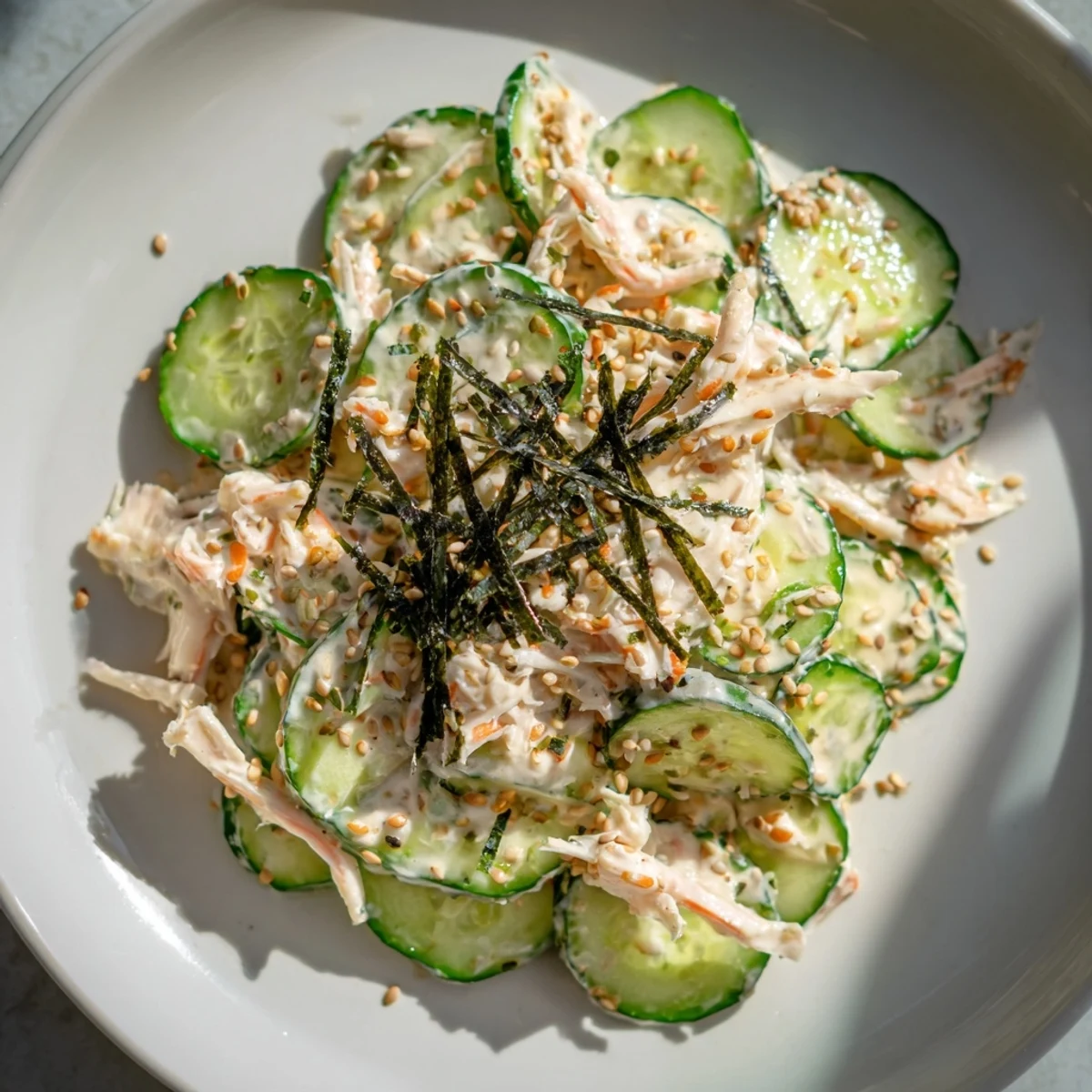California Roll Cucumber Salad, a vibrant mix of cucumbers and crab, drizzled with creamy dressing.