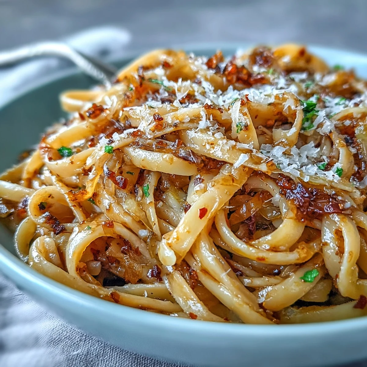 Golden caramelized cabbage and sliced garlic mingle with al dente spaghetti in a skillet, ready for Parmesan.