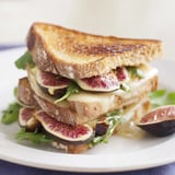 A close-up shot of a Fig, Brie & Arugula Grilled Cheese, perfectly toasted with crispy bread.