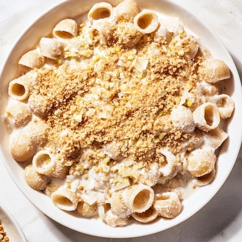 Creamy miso ditalini, a bowl of rich pasta with toasted sesame seeds and vibrant green scallions.