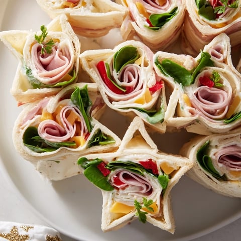 Party Sandwiches: Star-shaped deli roll-ups, filled with savory meats and fresh vegetables.