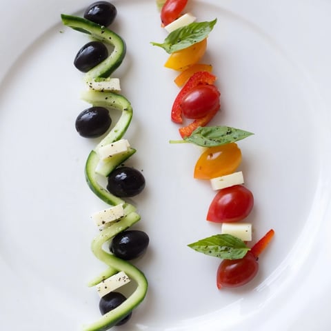 Double Helix Genetic Code appetizer: vibrant layers of olives, tomatoes, and cheese, ready to serve.