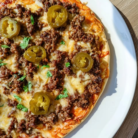 Delicious Spicy Ground Beef Pizza Base, with bubbly cheese and a drizzle of hot honey.
