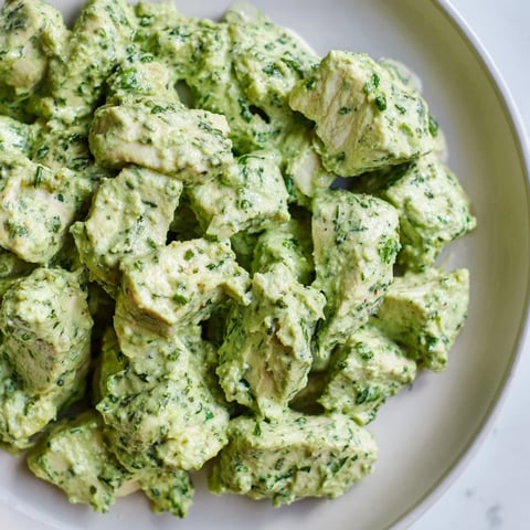 Juicy baked chicken chunks in creamy Green Goddess dressing, served over crisp mixed greens with cherry tomatoes and avocado slices.