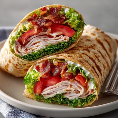 Close-up of layered Classic Turkey Club Wraps ready for a quick and easy lunch.