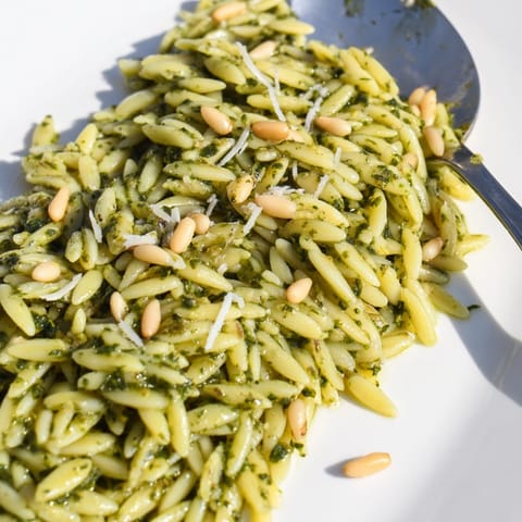Close-up of perfectly cooked Spinach Pesto Orzo with a sprinkle of parmesan, Italian-inspired.