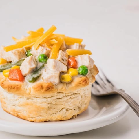 Creamy Cajun Chicken Ranch Pot Pie Cups, biscuit crust, with tempting melted cheese.