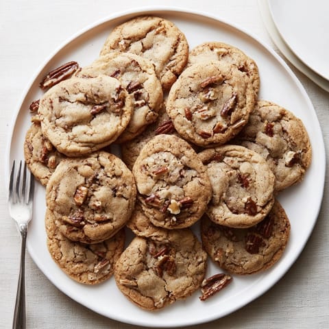 Freshly baked Cinnamon Date Pecan Cookies cooling on a rack, perfect for pairing with coffee.