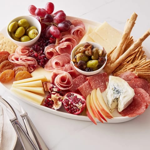 Deliciously arranged charcuterie board featuring maple glazed nuts, cheeses, and savory meats.  