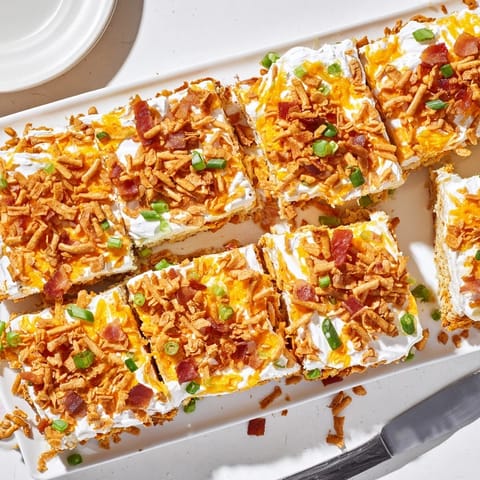 Savory Loaded Jalapeño Pretzel Sheet Cake garnished with crunchy pretzels and scallions.  