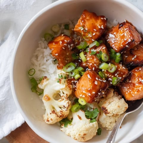Colorful Sriracha Honey Salmon Bowls featuring caramelized fish and crunchy sesame toppings.  