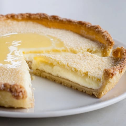 Creamy Water Pie topped with whipped cream and fresh berries for serving.  