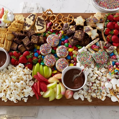 A delightful spread of Dessert Boards featuring sweet treats and vibrant chocolate-covered snacks.  