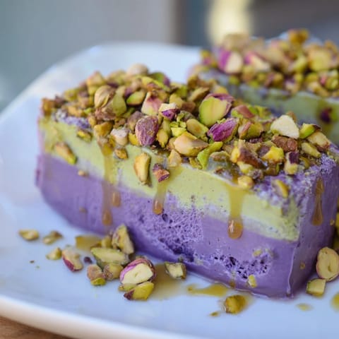 Vibrant ube and nutty pistachio ice cream bars, perfect for summer gatherings and treats.  