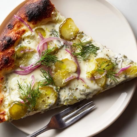 Delicious Pickle Pizza with melted mozzarella and crumbled dill garnish for extra zest.  