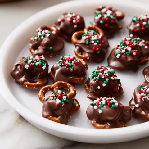 Delicious Air Fryer Christmas Pretzel Bites showcase perfectly melted chocolate with festive sprinkles for a quick dessert.