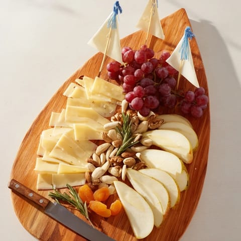 Sailboat Cheese Platter: A beautifully arranged platter with cheeses, fruit, and crackers ready to enjoy.