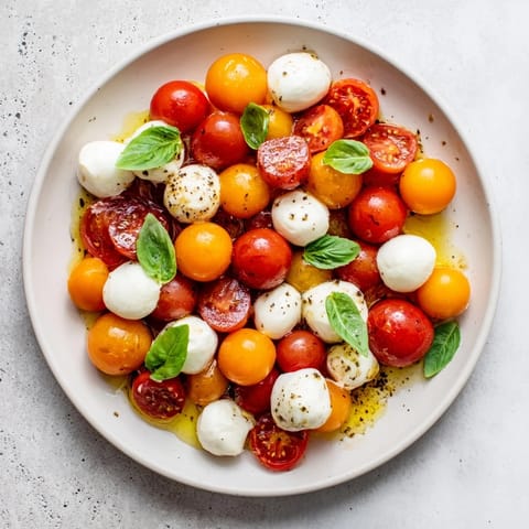 Fresh basil and mozzarella surround vibrantly hued cherry tomatoes in this simple Appertizer Wreath recipe.