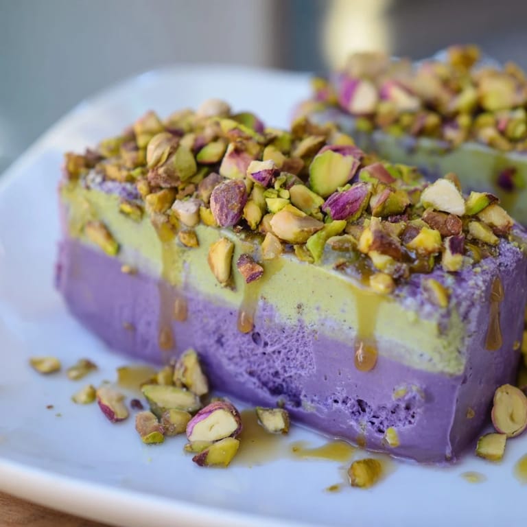 Vibrant ube and nutty pistachio ice cream bars, perfect for summer gatherings and treats.  