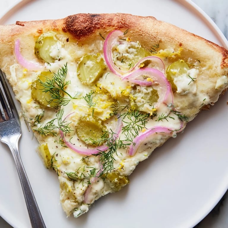 Irresistible Pickle Pizza featuring rich crème fraîche and colorful toppings for adventurous eaters.