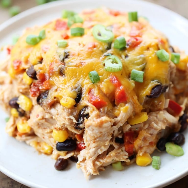A delicious, cheesy Taco Bell Copycat Chicken Bake, showing the warm, bubbling filling of this easy casserole dish.