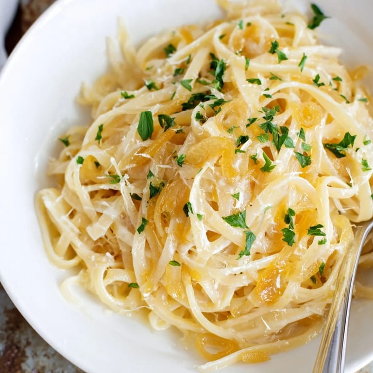 Close-up of bubbling One-Pot French Onion Pasta, with melted cheese and tender pasta in the pot.