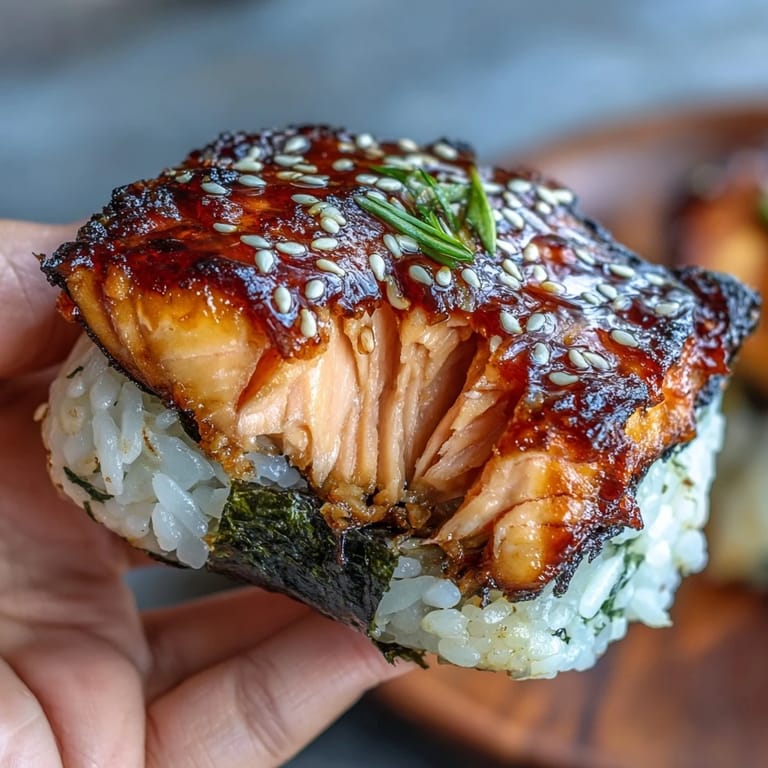 Delicate Japanese rice balls filled with succulent grilled salmon, crisped on the outside for a satisfying handheld treat.