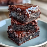Decadent triple chocolate sourdough brownies infused with espresso, featuring a fudgy texture and rich, layered chocolate flavors.